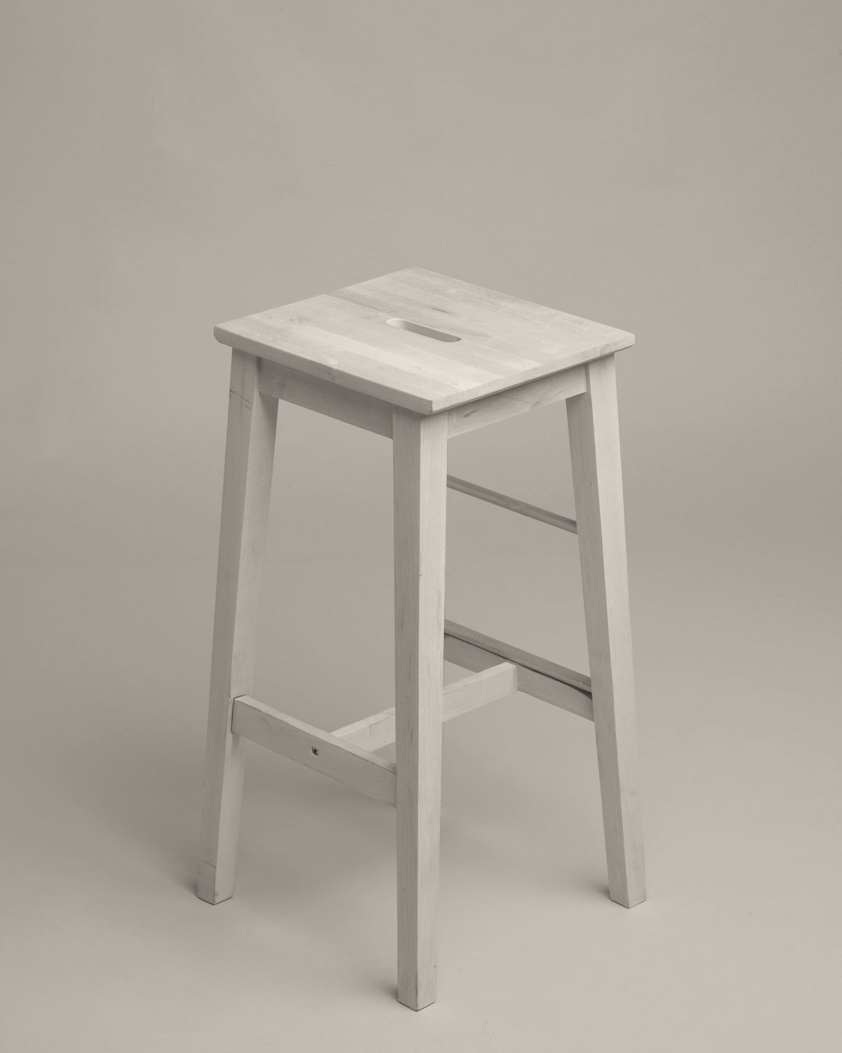 Atelier Stool in solid ash, photographed in a warm neutral studio