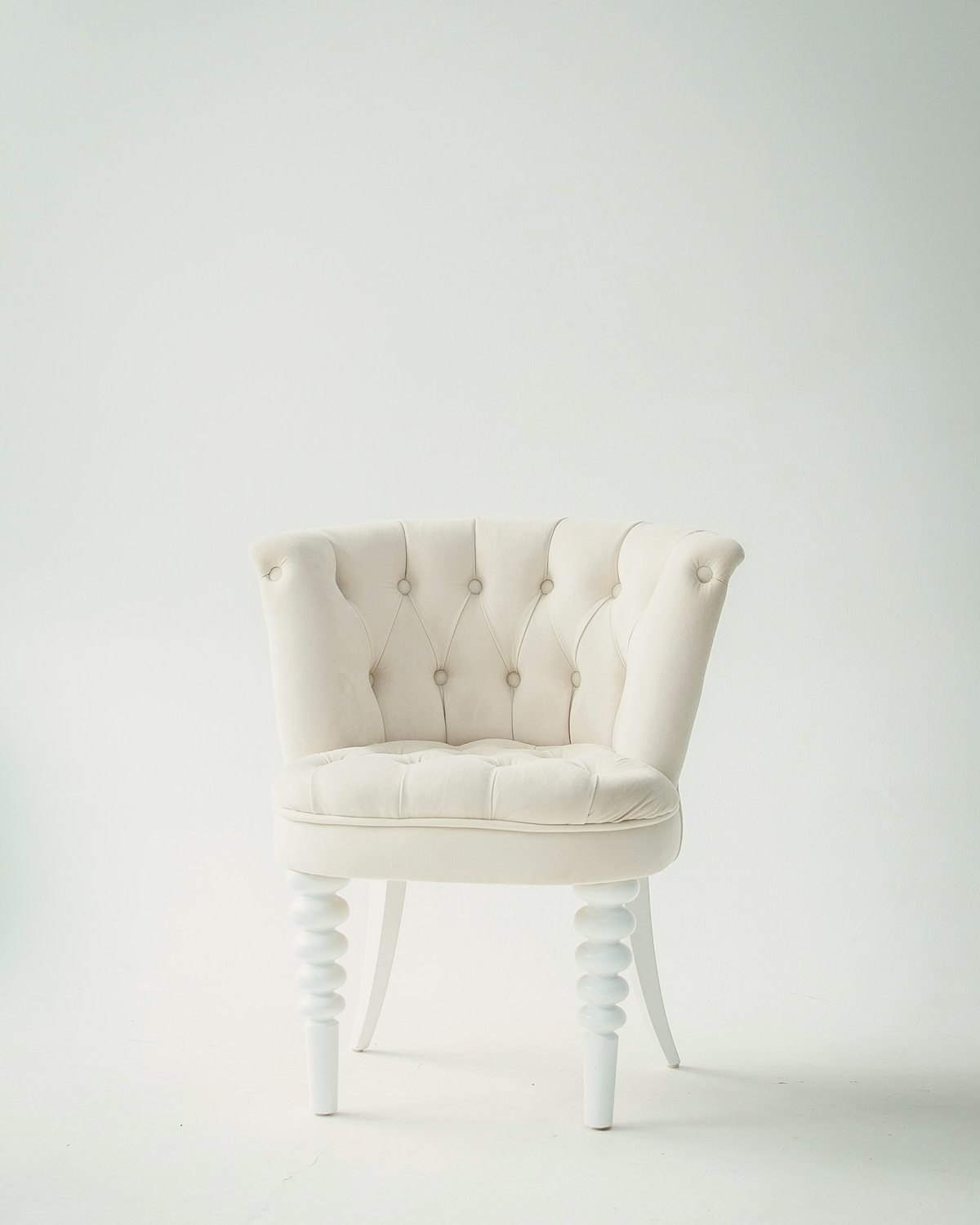 Bone Occasional Chair with a tufted ivory upholstered seat